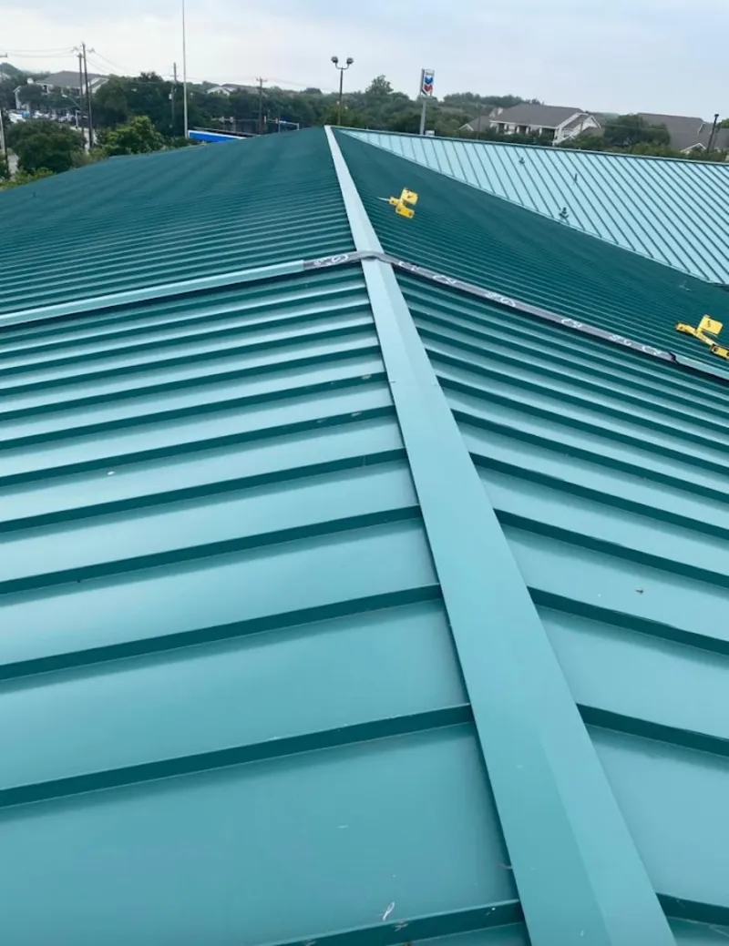 Green commercial metal roof ridge and valley for Metal Roof Repair in River Oaks