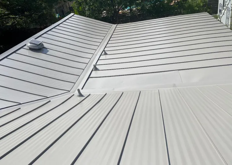 Solar attic fan installed on a metal roof for Roof Ventilation in River Oaks