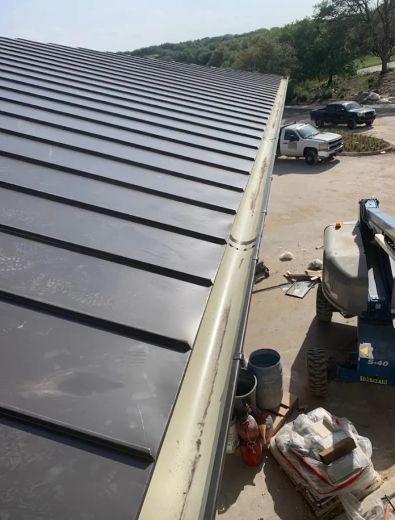 Standing seam panel and gutter detail on a metal roofing jobsite in River Oaks